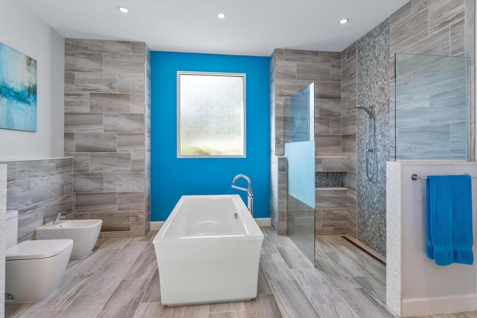 primary bathroom with porcelain tub and walk in shower
